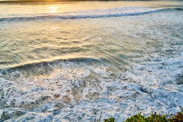 Stormy waving sea during sunset