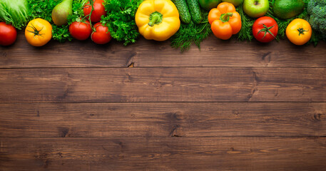 Healthy eating ingredients: fresh vegetables, fruits and superfood. Wooden background