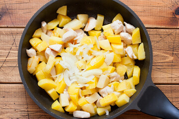 Step by step cooking fried potatoes with chicken fillet and onions, step 4 - adding chopped onions, top view
