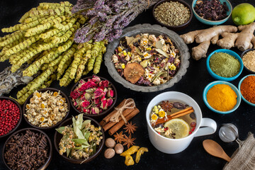 Large variety of multi colored dried tea leaves and flowers on the table