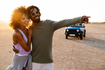 Image of african american couple walking while travelling with car