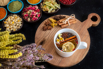 Large variety of multi colored dried tea leaves and flowers on the table