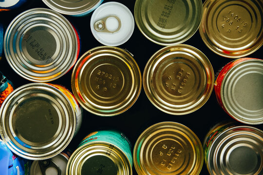 Various canned food in metal cans, top view