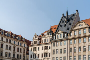 historic buildings in the city center of Leipzig under a ble sky