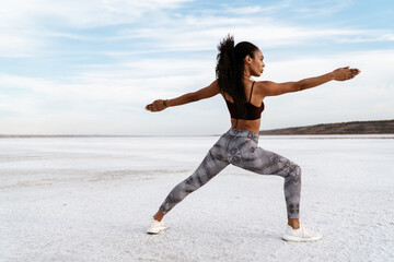 Image of african american sportswoman doing exercise while working out