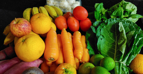 A small variety of fruits and vegetables that have just arrived from the organic fair.