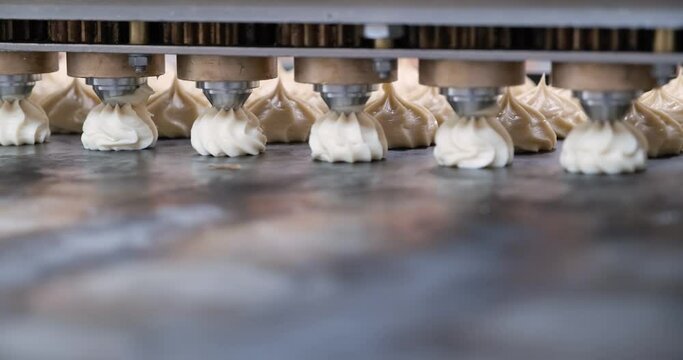the process of depositing marshmallows or profiteroles on the jigging machine