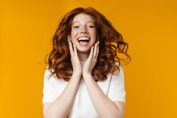 Image of redhead excited girl laughing and looking at camera