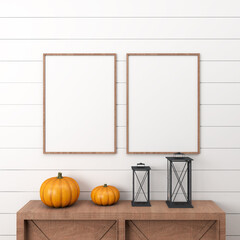 Two wooden halloween frames on a white wall, with a drawer with two pumpkins and black lanterns