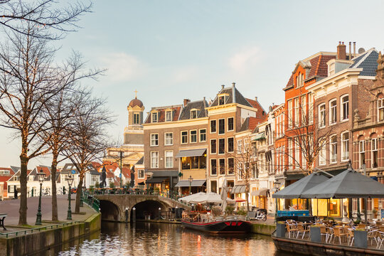 Afternoon view of the Nieuwe Rijn canal with bridge and historic buildings in the city center of Leiden