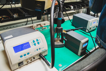 Work in the workshop with an electric soldering iron