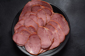 Smoked sliced beef  on black plate