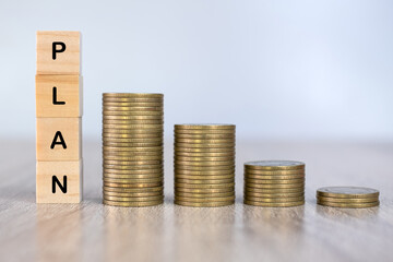 A pile of coins and blocks that write the words plan successful financial planning ideas Saving money and saving money