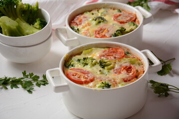 Broccoli, cheese and  egg casserole in baking cocottes