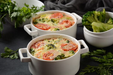 Broccoli, cheese and  egg casserole in baking cocottes