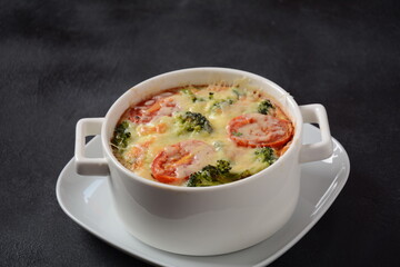 Broccoli, cheese and  egg casserole in baking cocottes