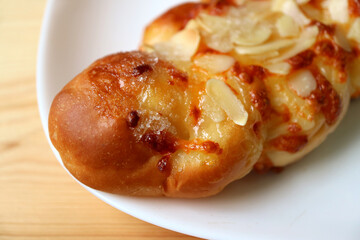 Closeup of a Homemade Sweet Almond Twist Bread on a White Plate
