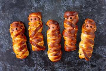 Scary sausage mummies in dough for kids party. Funny crazy Halloween food for children.