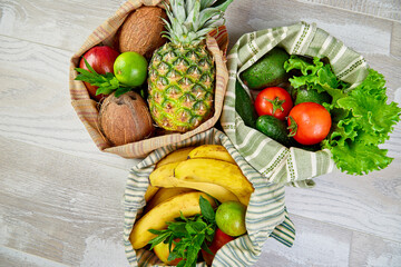 Flat lay of eco friendly grocery shopping cotton bags with organic fruits and vegetable