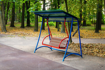 Empty swing in autumn park without people