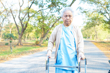 Asian senior or elderly old lady woman patient walk with walker in park : healthy strong medical concept