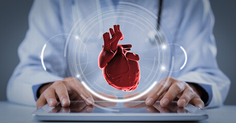 Doctor in coat using tablet with virtual heart hologram