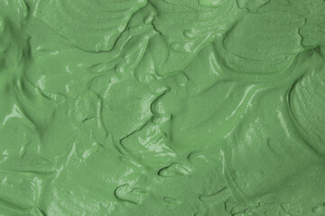 Green natural cosmetic face mud, textured background. Green clay face mask, close up	