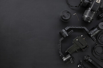 top view of work space photographer with digital camera and accessory on black background with copy...