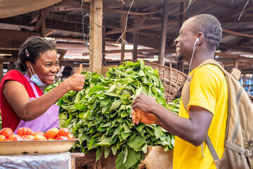 excited female african seller gives a man a thumbs up
