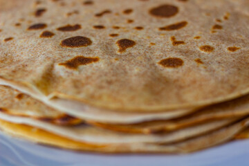 homemade pancakes on a plete with yellow and white background close up