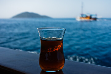 Enjoy cup of turkish tea on a boat heading to Kekova island, near city of Kas, Turkey