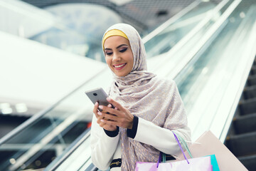Young Arabian Woman Using Smartphone on Shopping.