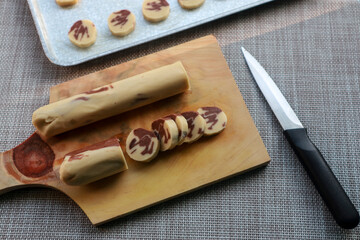 Cutting homemade butter cookie dough ready to bake