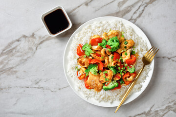 Asian cashew chicken on a white marble background