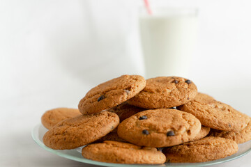 Oatmeal cookies and a glass of milk in the background. Selective focus. Copy space.