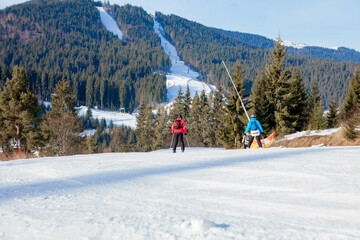 Skiing people and the chair lifts of ski region in Ukraine