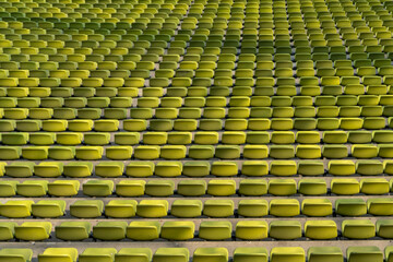 endless rows of enpty chairs in a stadium