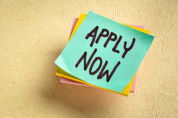 Apply now - handwriting on a reminder note, business marketing concept