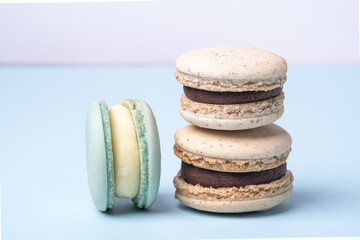 Close up of delicious french macarons. Different types of macaroons on a blue background