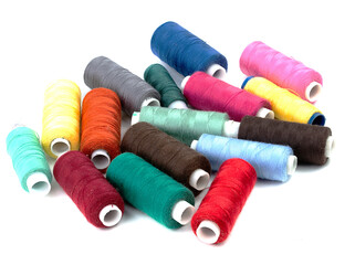 Coils of colored thread on a white background