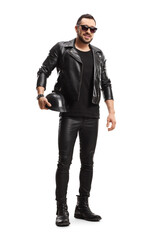 Full length portrait of a biker in leather jacket and pants holding a leather helmet