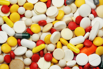 Different colorful tablets at white background	