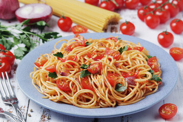 A plate with spaghetti with tomatoes	