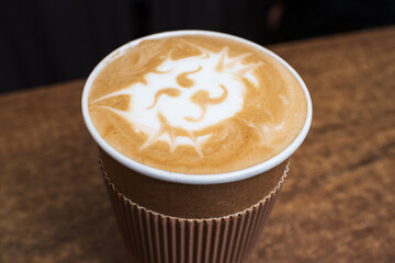 Delicious, aromatic and refreshing cappuccino coffee with a cat pattern in a disposable plastic cup