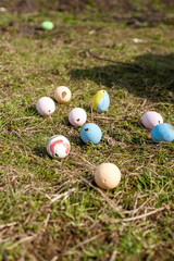painted eggs in different colors lie on the grass