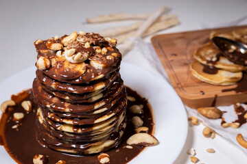 chocolate pancake with bananas, nuts and chocolate sauce. the toning. Top view.