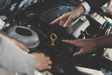 The seller shows the motor of the car. 