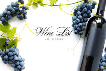 wine list background; sweet black grapes and red wine bottle