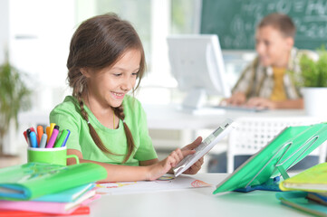 Cute teen girl doing homework in her room