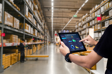 Smart warehouse management system.Worker hands holding tablet on blurred warehouse as background - obrazy, fototapety, plakaty